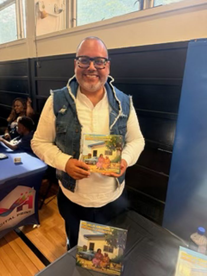 Edward Rodriguez holding his book at the Uniondale High School writing celebration