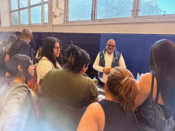 Edward Rodriguez speaking with a group of students and families